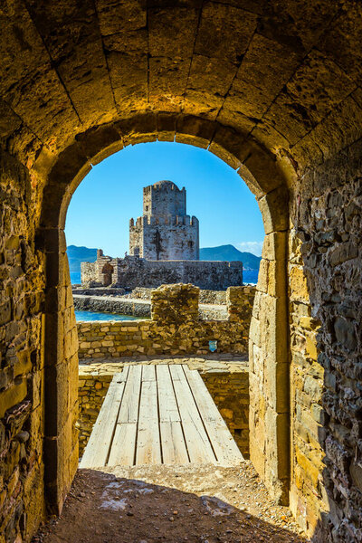 Venetian fort castle Methoni. The three-tiered watchtower is built on long cape in the sea. The concept of active, photo and historical tourism