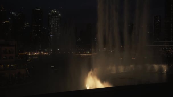 Dubai Fountain is the worlds largest choreographed fountain system on the Burj Khalifa Lake at night stock footage video — Stock Video