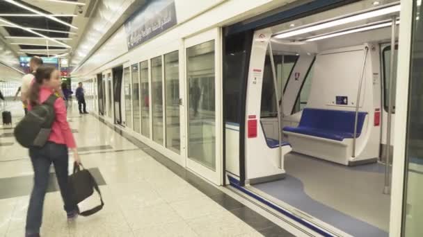 Train pour la livraison des passagers de la zone des arrivées à la zone de récupération des bagages à l'aéroport international de Dubaï images vidéo — Video