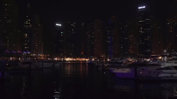 Nattvisning av hamnen med båtar i dyra turistområdet Dubai Marina arkivfilmer video — Stockvideo