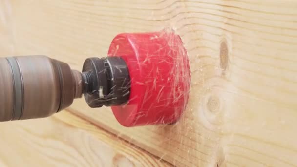 Electric drill with a nozzle for outlets makes a hole in wooden wall stock footage video — Stock Video