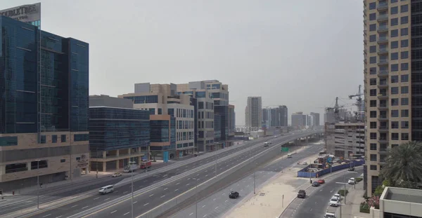 Estrada entre arranha-céus modernos no centro de Dubai — Fotografia de Stock