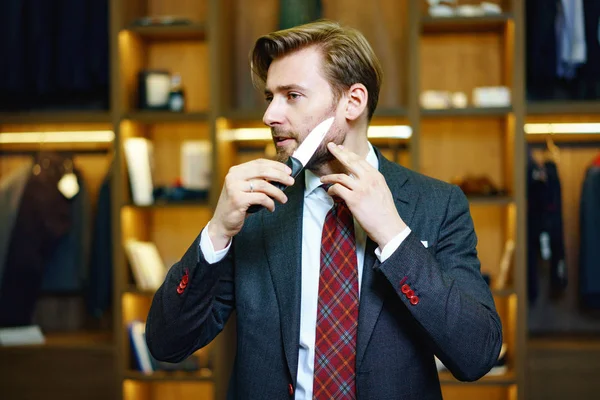 Successful man in clothes showroom — Stock Photo, Image