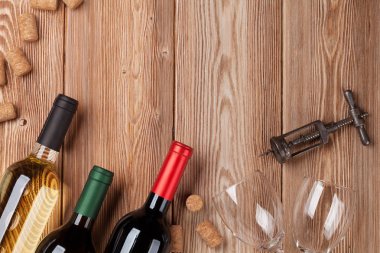 Ahşap masa üzerinde şarap şişeleri. Kırmızı ve beyaz şarap. Metin alanı olan üstten görünüm