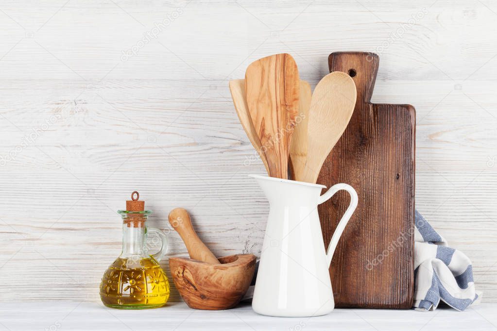 Kitchen utensils in front of wooden wall with space for your text