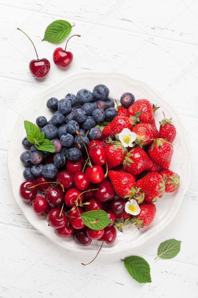 Fresh summer berries. Cherries, blueberries, strawberries in bowl. Top view