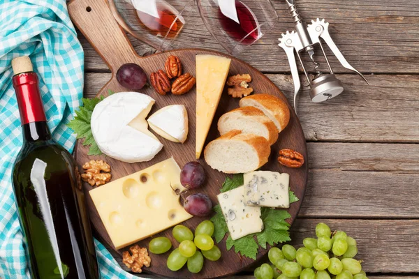 Wine, cheese, grape, bread and nuts. Top view with space for your text