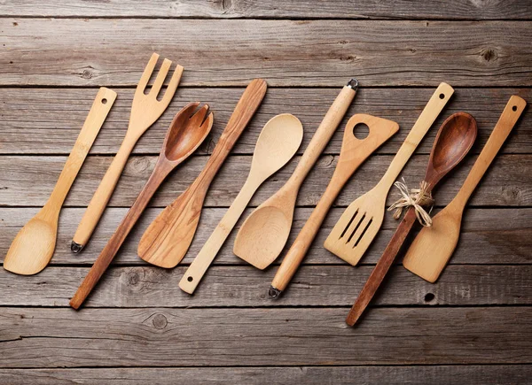Various cooking utensils over wooden kitchen table. Top view