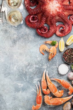 Deniz ürünleri ve şarap. Ahtapot, istiridye, ıstakoz, karides, istiridye yemek. Senin metin için yer ile taş tabloda üstten görünüm