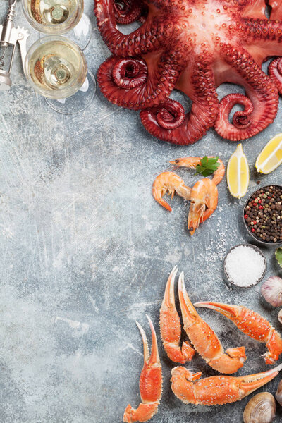 Seafood and wine. Octopus, oysters, lobster, shrimps, clams cooking. Top view on stone table with space for your text