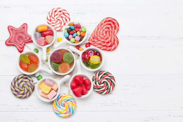 Colorful sweets box. Lollipops, marmalade and candies. Top view with space for your greetings