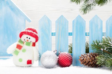 Christmas snowman toys, baubles and fir tree branch. Xmas decor