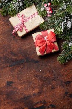 Noel hediye kutuları ve kar üzerinde ahşap arka plan kapsamında köknar ağacı dalı. Üstten görünüm xmas zemin alan selam ile