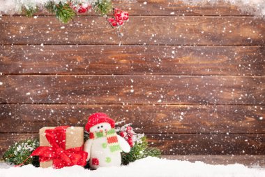 Noel tebrik kartı ile xmas ağacı ve kardan adam oyuncak ahşap duvar önünde. Selam ile alan