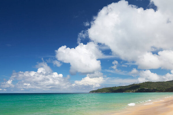 Tropical beach with bright sand and deep blue sea. Summer sea vacation and travel concept