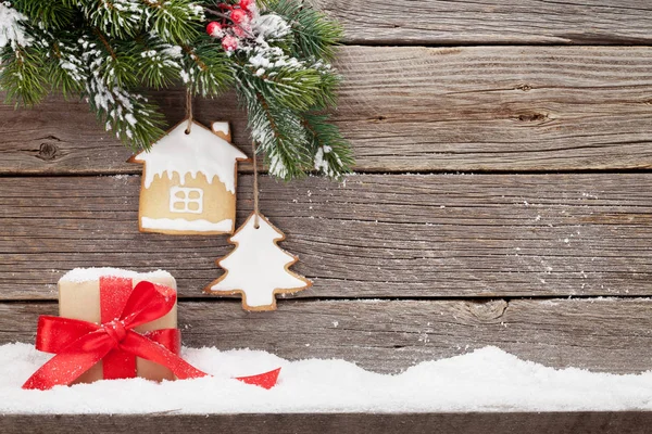圣诞贺卡 配有礼品盒 姜饼饼干和冷杉树枝 在木墙前被雪覆盖 用空间为您的问候 — 图库照片