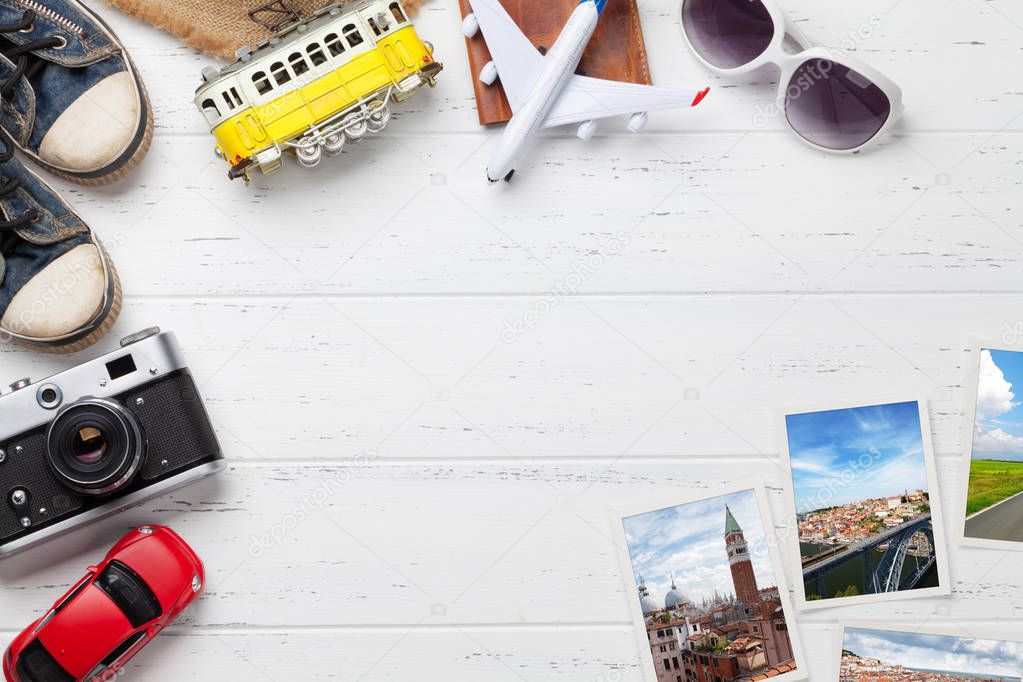 Travel vacation background concept with hat, camera, passport, car, tram, airplane toys and weekend photos on wooden backdrop. Top view with copy space. Flat lay. All photos taken by me