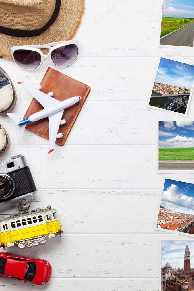 Travel vacation background concept with hat, camera, passport, car, tram, airplane toys and weekend photos on wooden backdrop. Top view with copy space. Flat lay. All photos taken by me