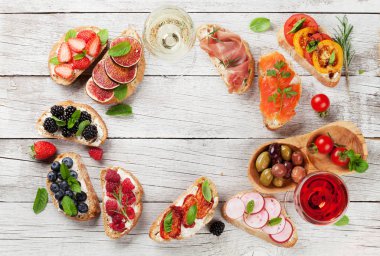 Brushetta veya geleneksel İspanyolca tapas. Meze İtalyan antipasti aperatifler şarapla ayarlayın. Üstten görünüm ve düz metin için yer ile göklere