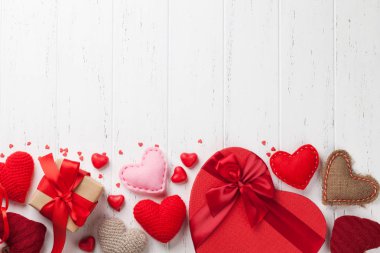 Valentine's day greeting card with handmaded heart toys and love gift boxes on wooden background. Top view with space for your greetings. Flat lay clipart