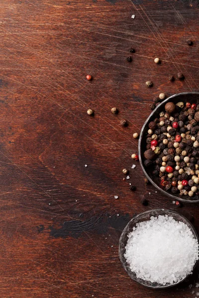 Spices for meat. Salt and pepper on wooden cooking table. Top view with space for your text