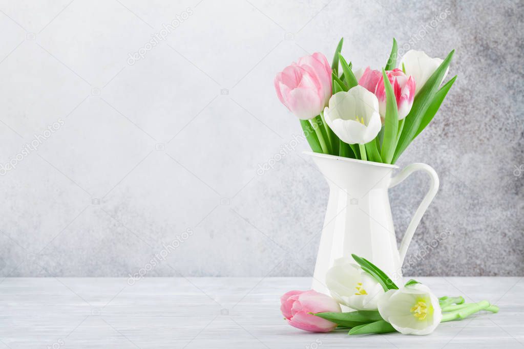 Easter greeting card with tulip flowers bouquet on white wooden background