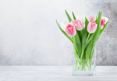 Lale çiçek buketi ile Paskalya tebrik kartı. Selam yeri olan taş duvarın önünde