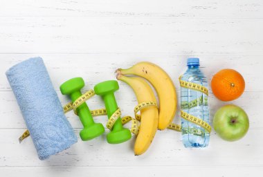 Dambıl ile meyve ve şerit ölçü içki şişesi, üstten görünüm, Fitness ve sağlıklı gıda kavramı ile.  