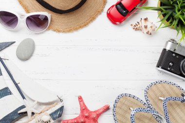 Tatil arka plan kavramı ile güneş şapkası, fotoğraf makinesi, oyuncak araba ve denizyıldızı ahşap zemin üzerinde seyahat