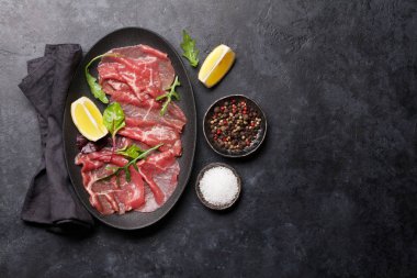 Mermer Dana carpaccio roka, limon ve biber ile