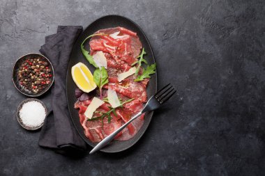 Mermer Dana carpaccio roka, limon ve Parmesan peyniri ile