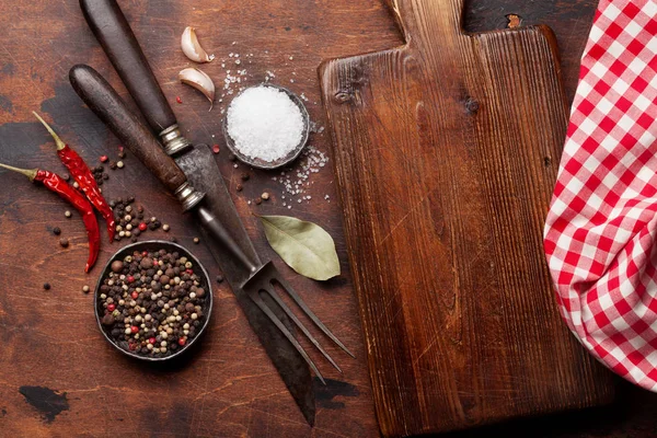 Various spices, herbs and vintage cooking utensils on wooden background