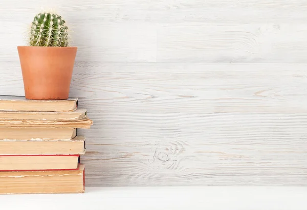 Home office workplace with stack of old books — Stock Photo, Image