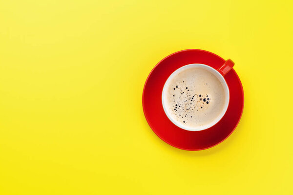 Red coffee cup over yellow background