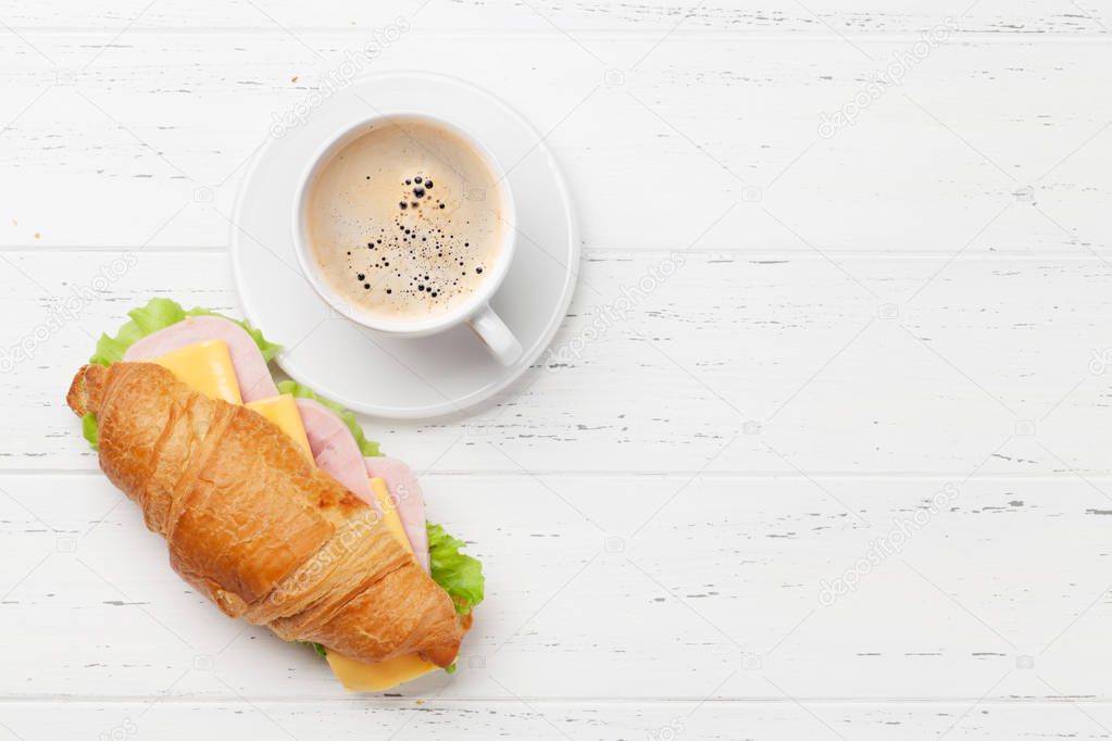 Coffee and croissant sandwich