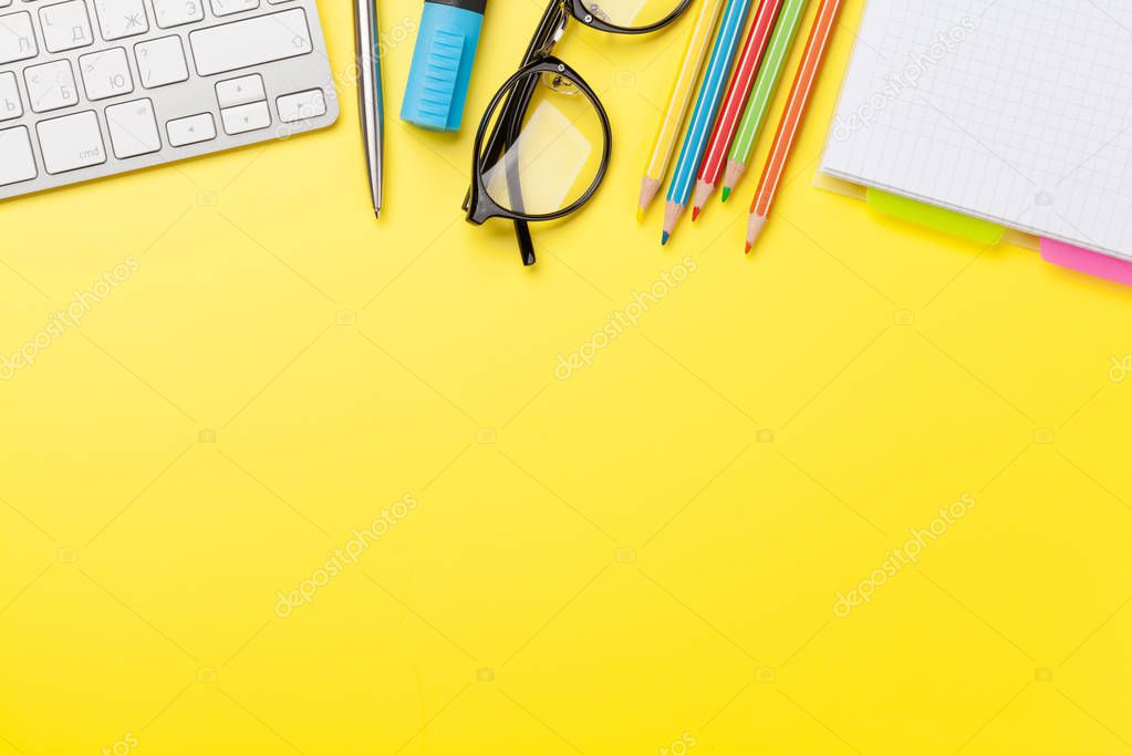 Office yellow backdrop with supplies and computer