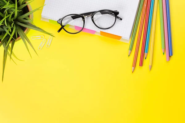 Office yellow backdrop with supplies and glasses — Stock Photo, Image