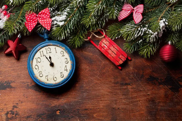 Christmas fir tree and alarm clock over old wood — Stock Photo, Image