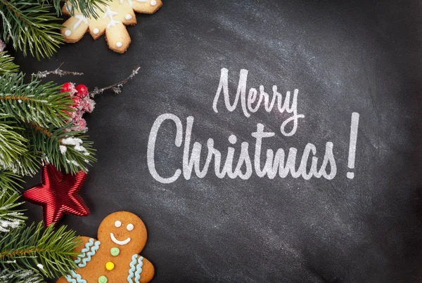 Galletas de Navidad y rama de abeto — Foto de Stock