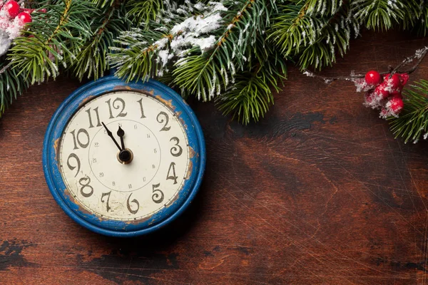 Christmas fir tree and alarm clock over old wood — Stock Photo, Image