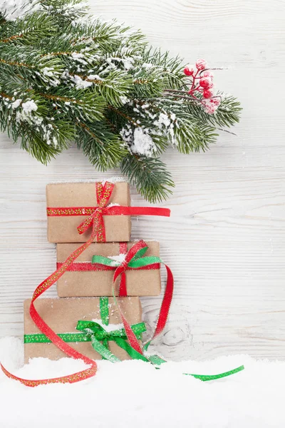 Christmas gift boxes and xmas fir tree — Stock Photo, Image