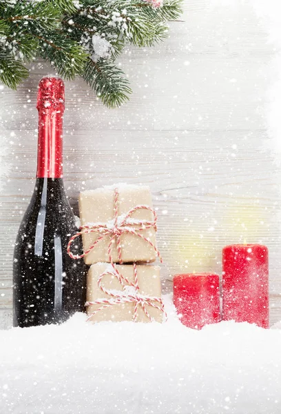 Christmas gift boxes and champagne bottle — Stock Photo, Image