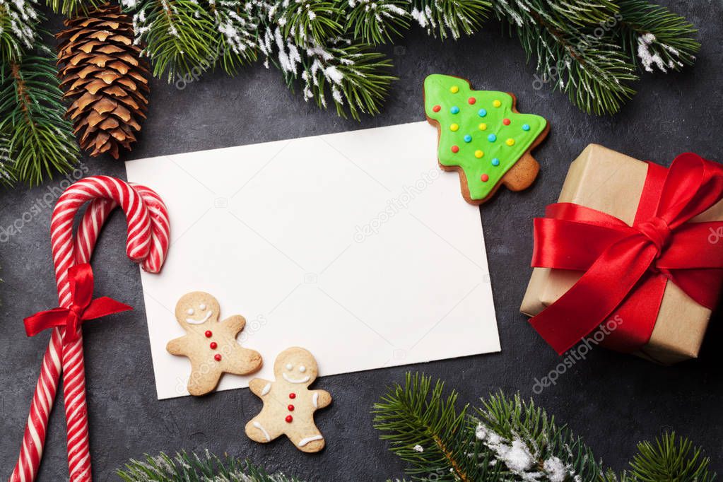 Christmas card with gingerbread cookies and fir tree