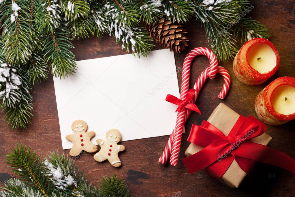 Christmas card with gingerbread cookies and fir tree