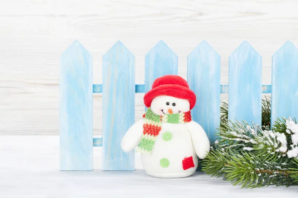 Christmas snowman toy and fir tree branch — Stock Photo, Image