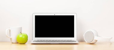 Dizüstü bilgisayarı ve kulaklığı olan bir stüdyo çalışma alanı. Ev kavramından çalış. Metnin için boş ekran ile