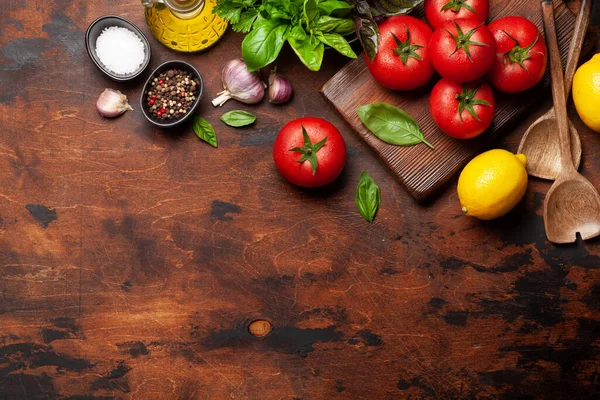 Italian cuisine ingredients. Garden tomatoes, herbs and spices. Top view with copy space. Flat lay