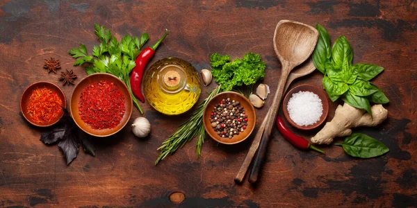 Various spices, herbs and condiments on wooden table. Indian cuisine. Top view flat lay