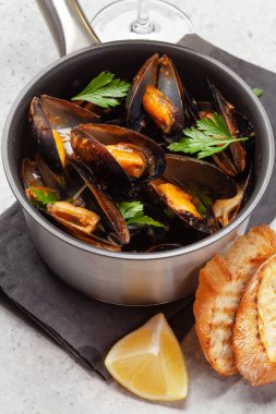 Geleneksel deniz ürünleri midyesi, şarap sosu ve baget tostu.