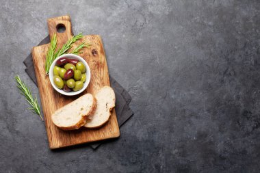 Olgun zeytin ve ciabatta ekmeği. Üst görünüm düzlüğü kopyalama alanı ile yatıyordu